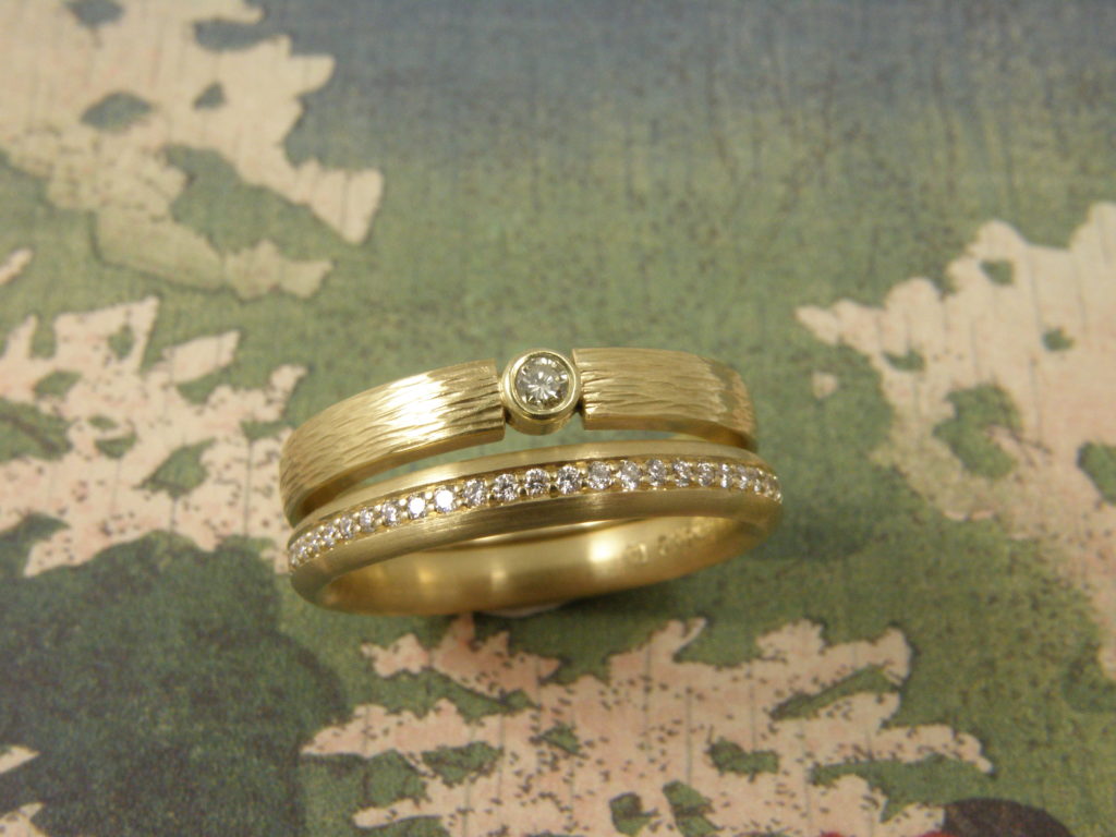 Geelgouden ringen ‘Ritme’ en ‘Eenvoud’ met briljant geslepen diamant, rondom Pavé gezet.
