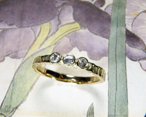Engagement ring 'Swell'. Yellow golden texture ring and 3 heirloom diamonds. Created in the Oogst studio in Amsterdam.