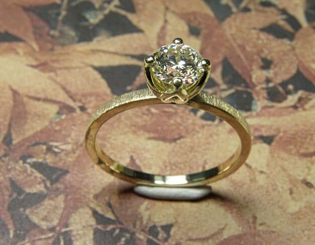 Engagement ring 'Velvet'. Yellow golden ring with a 0,59 carat diamond. Jewellery design by goldsmith Oogst in Amsterdam.