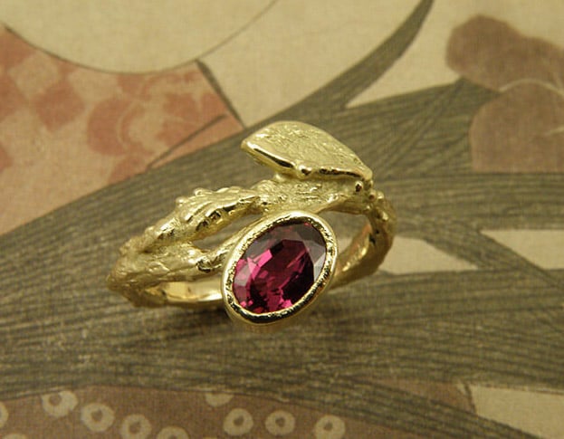 Engagement ring 'Orchard'. Yellow golden twig with leaf and oval ruby. Created in the Oogst studio in Amsterdam.