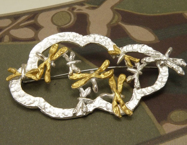Brooch with silver dragonflies with leaf gold on their wings. Made at Oogst atelier Amsterdam.