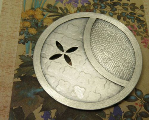 Silver brooch, circle shape with Japanese motives. Created at the Oogst studio in Amsterdam.