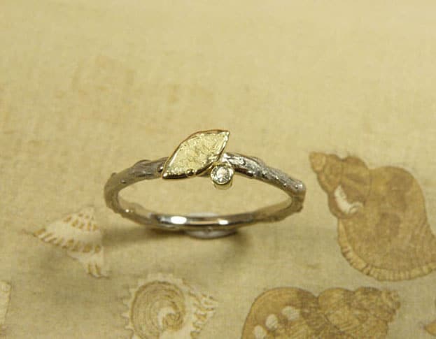 Engagement ring 'Orchard'. White golden twig ring with yellow golden leaf and a 0,02 crt diamond. Created in the Oogst studio in Amsterdam.