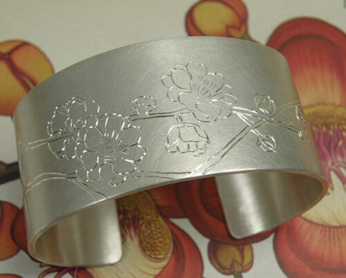 Zilveren klemarmband met Japanse kersenbloesem handgravure. silver cuff with hand engraved Japanese cherry blossom. Uit het Oogst atelier Amsterdam.