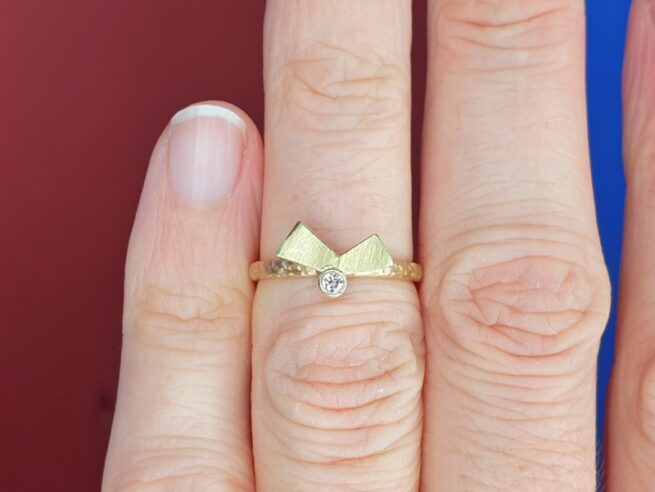 Rosé gold ring 'Folding' with yellow gold element with a 0,05 ct brilliant cut diamond. Design by Oogst Goldsmith in Amsterdam