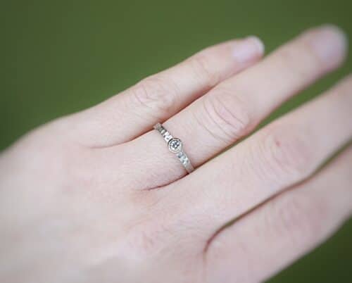 Engagement ring 'Swell'. White golden ring with texture and 0,10 ct diamond. Made at Oogst studio.