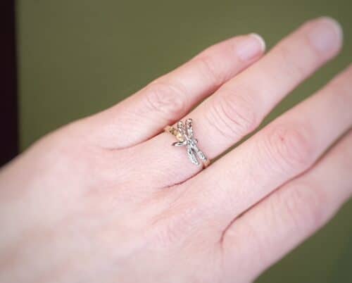 Yellow gold ring 'Insects' with a white gold dragonfly. Playful design by goldsmith Oogst in Amsterdam.