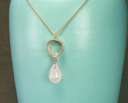 Rose gold pendant 'Lineair' with a rose quartz drop. Design by Oogst Jewellery in Amsterdam