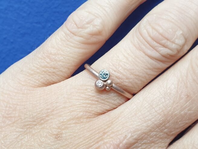 Roodgouden bessen ring met fancy ijsblauwe en lavendel diamant. Design van Oogst Sieraden.