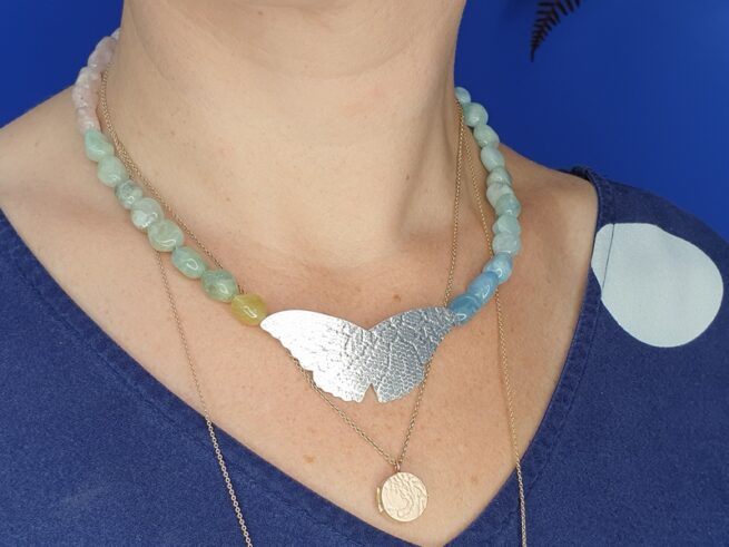 Gemstone necklace with beryl and a silver butterfly from the 'Insects' series. Design by Oogst Amsterdam