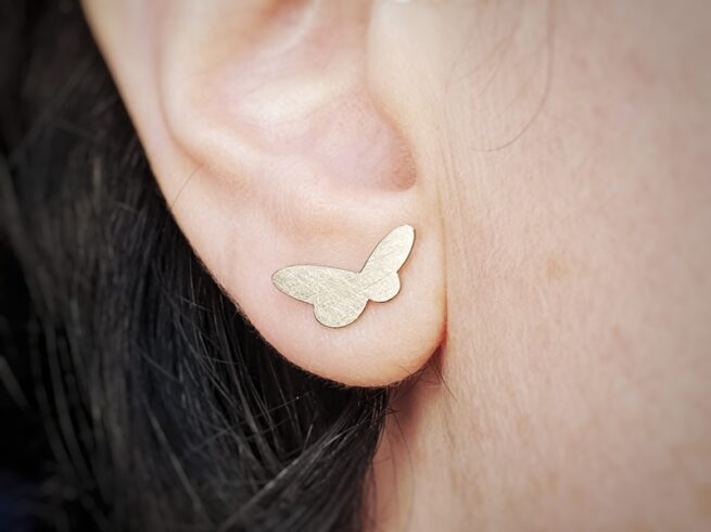 Golden ear studs from the 'Insects' series. White gold butterflies. Standout design by Oogst jewellery in Amsterdam