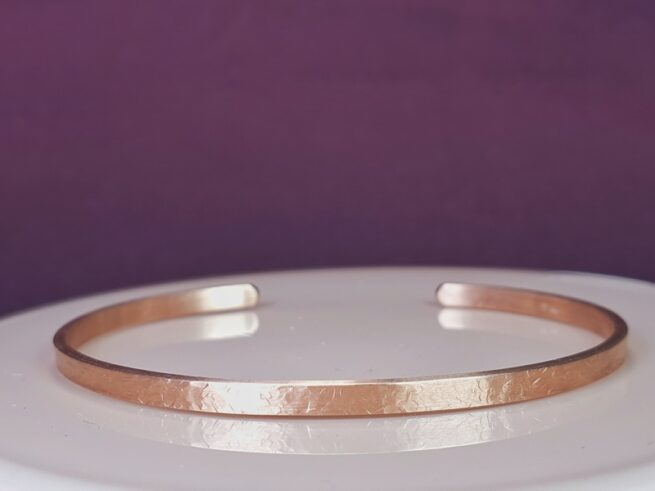 Rose gold cuff bracelet with hammered texture. Design by Oogst Jewellery in Amsterdam.