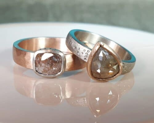 Wedding rings 'Rhythm'. Rose and white gold hammered wedding rings with natural diamaonds. Created by Oogst goldsmith in Amsterdam.