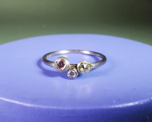 Verlovingsring Verzameling witgouden fijne ring met roosgeslepen diamant, besje en roze diamant in een boleet zetting. Verfijnde verlovingsring. Ontwerp van Oogst Goudsmeden in Amsterdam