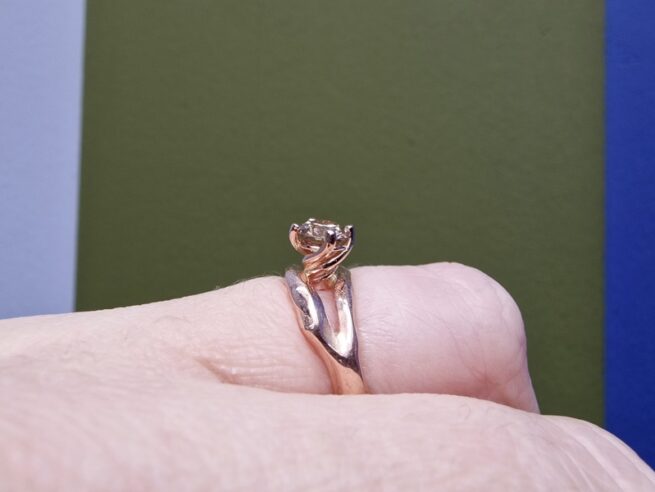 Rose gold engagement ring 'Wave' with a champagne diamond and a soft flowy open shape . Bold design by Oogst jewellery in Amsterdam. On the finger