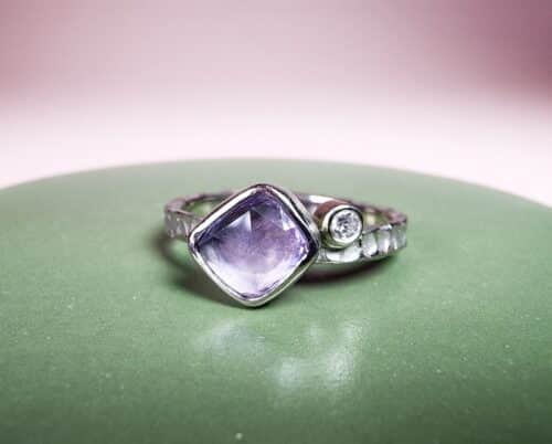 Witgouden 'Deining' ring met violet korund en diamant. Sieraadontwerp van Oogst goudsmeden Amsterdam