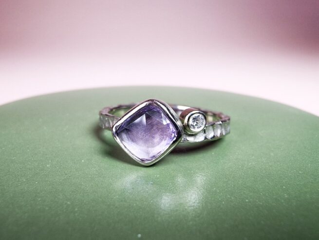 Witgouden 'Deining' ring met violet korund en diamant. Sieraadontwerp van Oogst goudsmeden Amsterdam