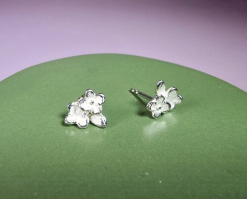 Forget me nots silver Flowers ear studs. Design by Oogst goldsmith in Amsterdam. Independent jewellery designer.