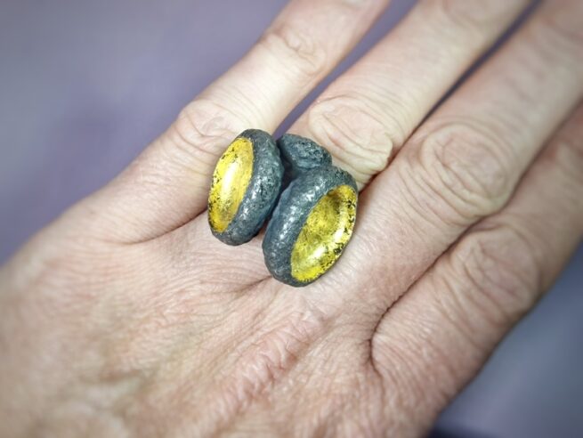 Silver statement ring Oak. Oxidised acorns with gold leaf. Jewellery design by Oogst goldsmith studio in Amsterdam