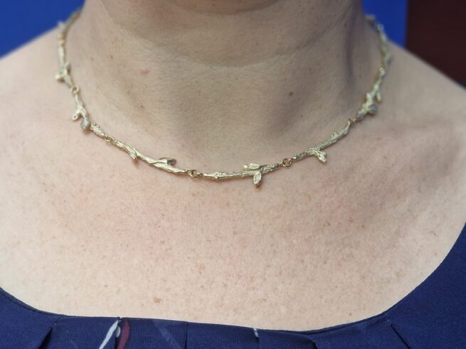 Yellow golden twigs necklace from the Orchard series with playful leaves. Timeless design by Oogst Jewellery