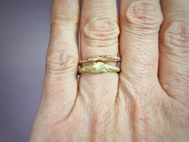 These golden 'Mountain' stack rings have an interesting contour, a sturdy texture and yet a refined size. In rose, yellow, white and rosé gold. Design by Oogst jewellery in Amsterdam. Seen on the finger