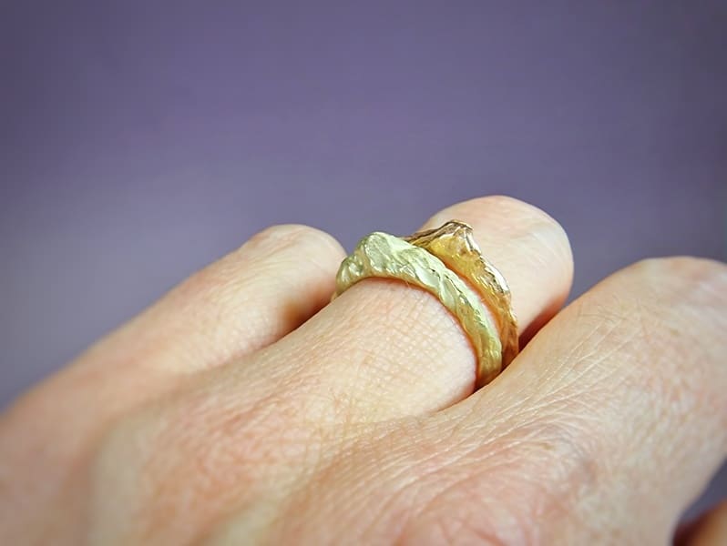 These golden 'Mountain' stack rings have an interesting contour, a sturdy texture and yet a refined size. In rose, yellow, white and rosé gold. Design by Oogst jewellery in Amsterdam. Seen on the finger