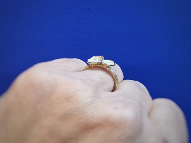 Yellow gold Fungus on a twig ring. Design by Oogst  Jewellery in Amsterdam. Ring on finger.