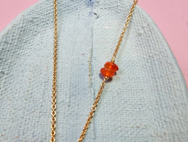 Golden necklace Cloud with an accent of Carnelian. Detail of gemstones. Jewellery design by Oogst in Amsterdam.