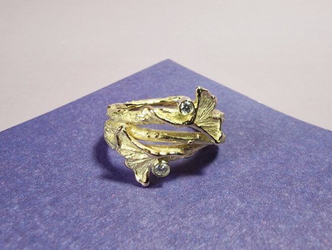 Yellow gold twig statement ring with dainty Ginkgo leaves and diamonds. Created by Oogst Jewellery.