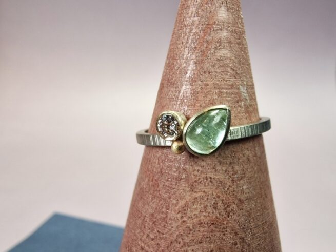Refined white gold 'Cluster' ring with a pear shaped aquamarine and twinkling diamond. Created at the Oogst goldsmith studio.