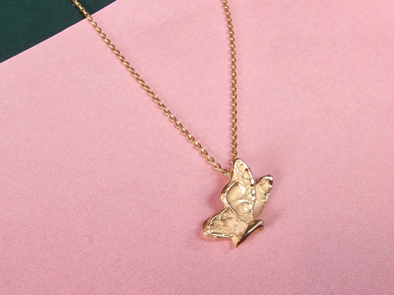 Rosé golden 'Butterfly' pendant from our 'Insects' series with a playful texture. Elegant everyday piece created at the Oogst studio.