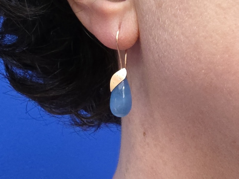 Blaadjes oorsieraden met aquamarijn pampels in roodgoud met elegante krullen. Eenmalig modern paar uit het Oogst atelier. Onder het oor bungelend.