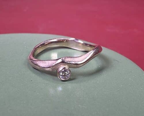 Verfijnde roodgouden Golf verlovingsring met een 0,06 ct bruine diamant. Uit het Oogst atelier.