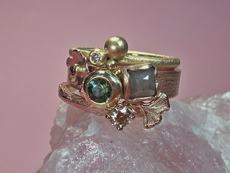 Stack rings Ginkgo, Cluster and Berries, all created at the Oogst goldsmith studio. A mix of yellow gold and rose gold, diamonds and tourmaline.